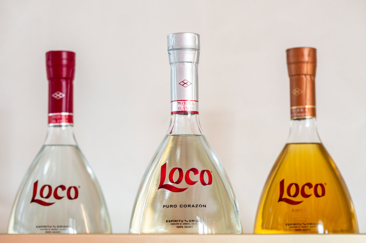 three bottles of loco tequila