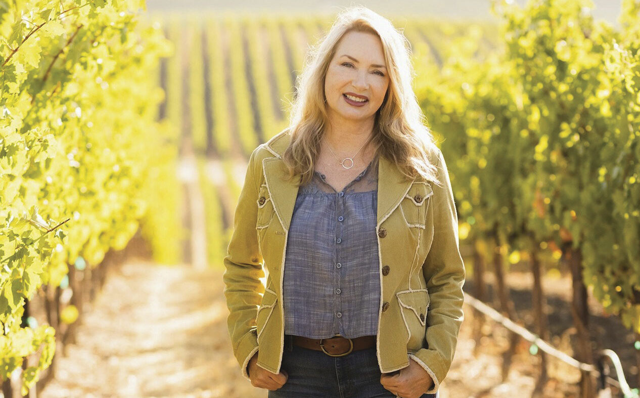 Cynthia Lohr standing in a vineyard