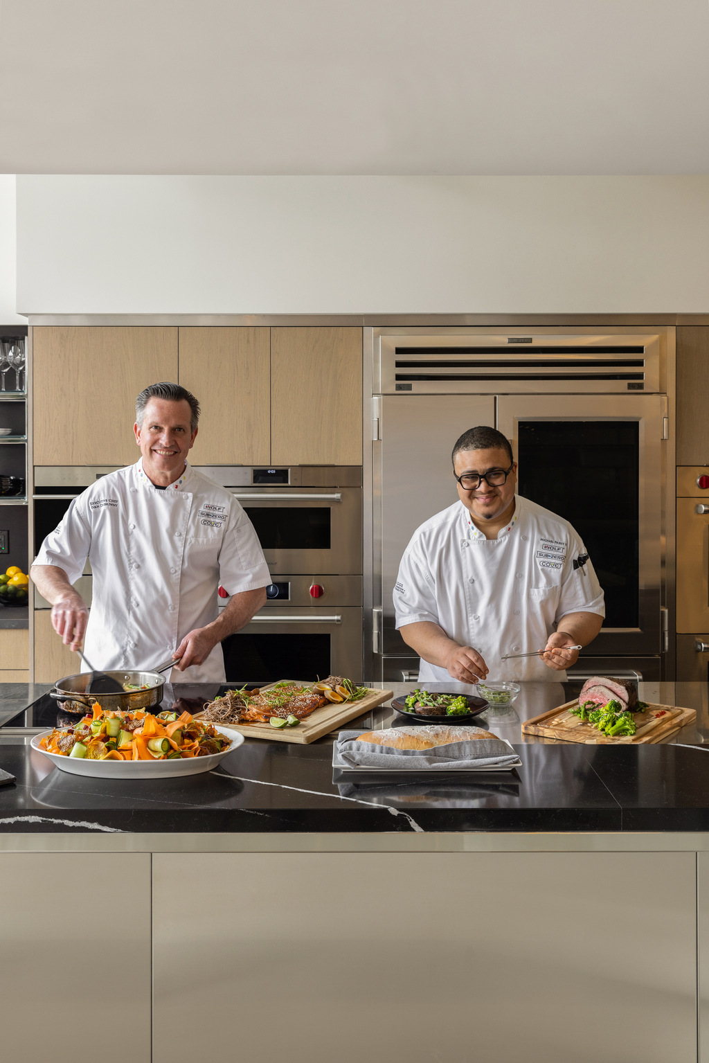 two chefs prepare a demonstration meal at Riggs' showroom