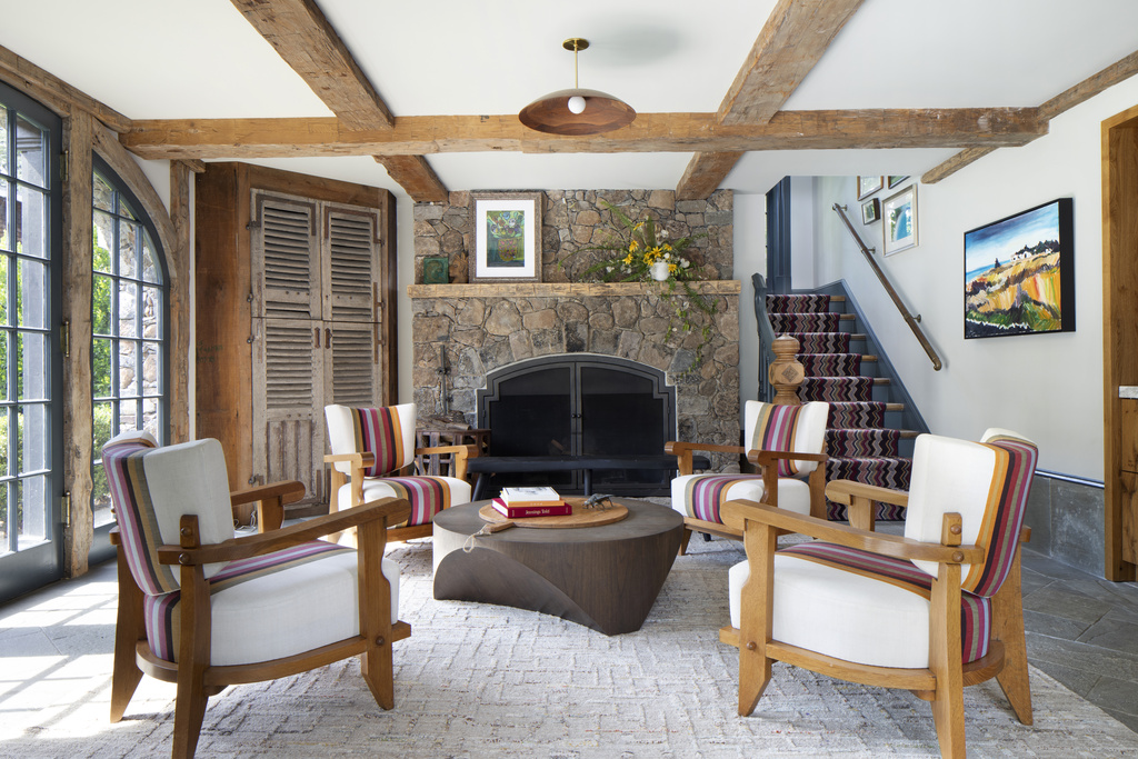 a family room with seating in front of the fireplace