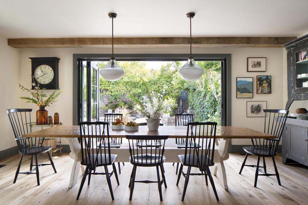 dining room table with rustic seating and open doors