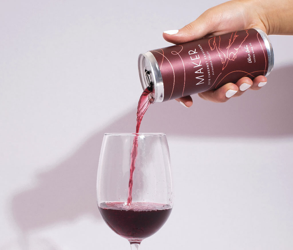 a can of maker wine pours into a glass