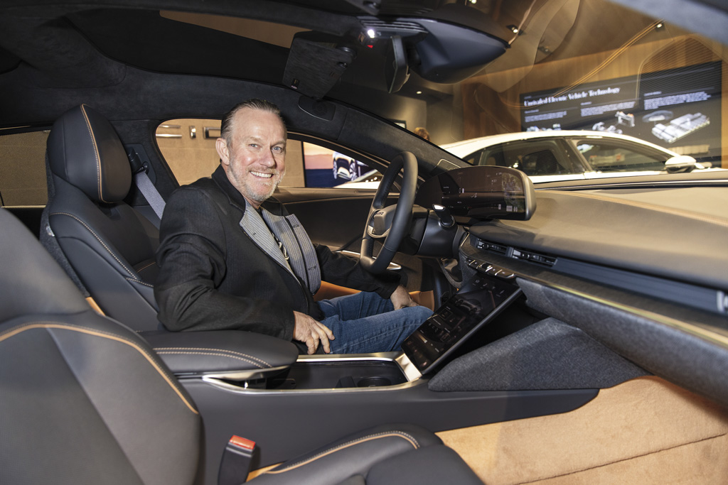 a man sits in a Lucid electric car