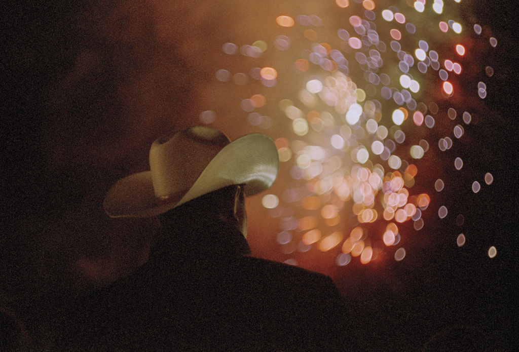 a man in a cowboy hat watching fireworks at the Marin County fair