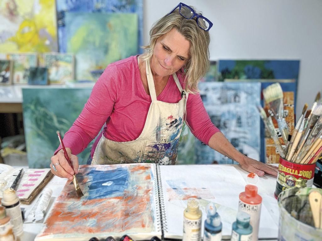 Margie Woods working on a painting
