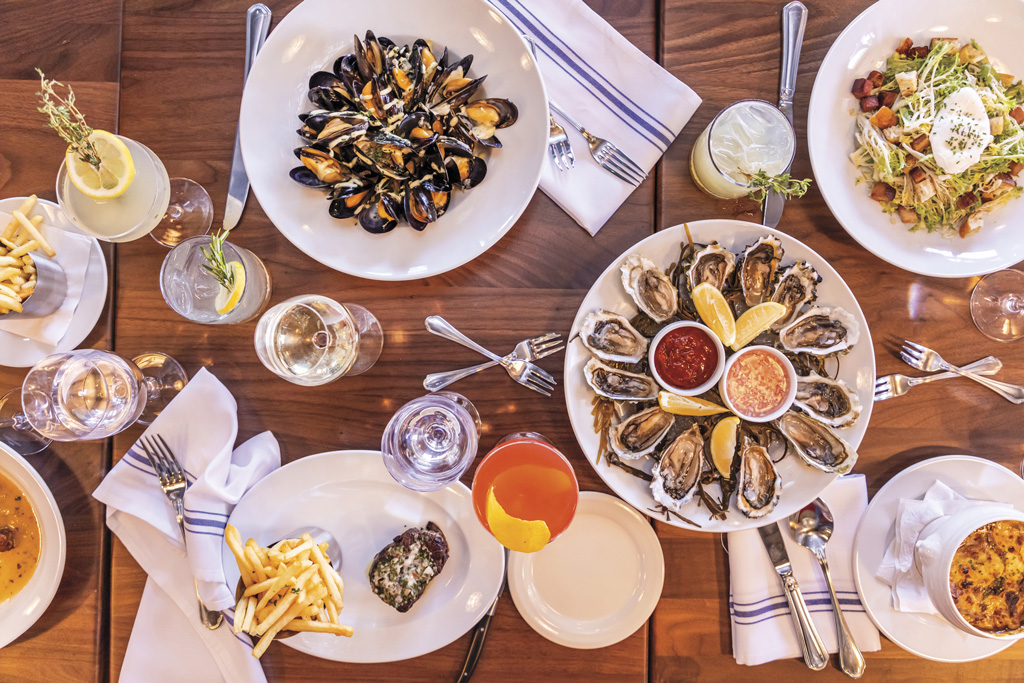 a table full of oysters and brunch dishes